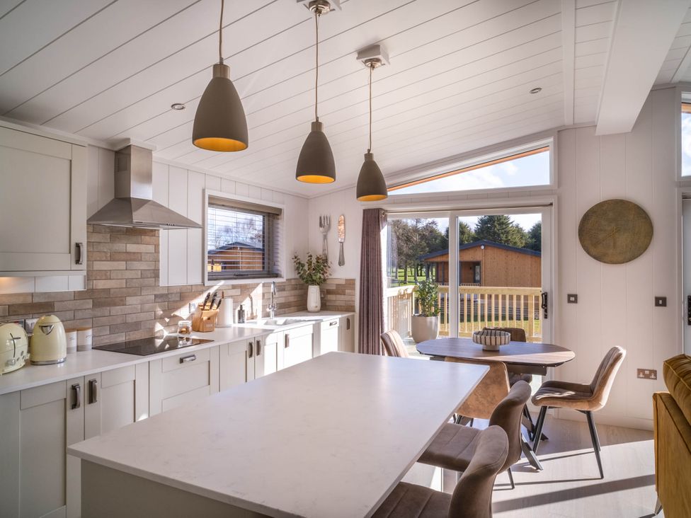 A kitchen with an island and dining table at Luxurious Serenity in Waltham