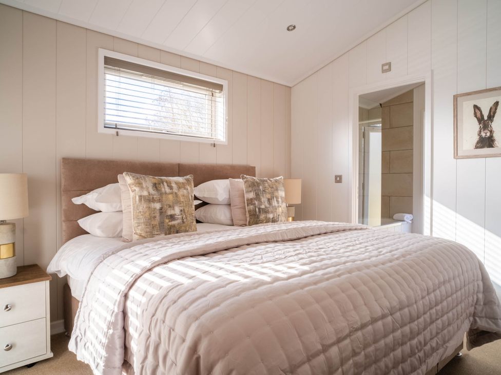 A bedroom with a bed and lamp at Luxurious Serenity in Waltham