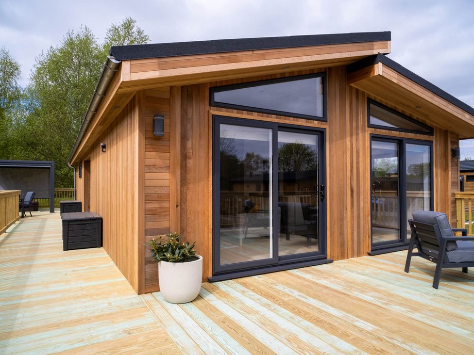 An outdoor area with seating and large windows at The Luxury Escape in Waltham