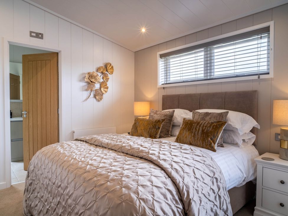 A bedroom with a bed and bedside table at The Luxury Escape in Waltham