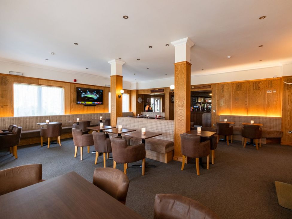 A dining room with tables and chairs at The Luxury Escape in Waltham