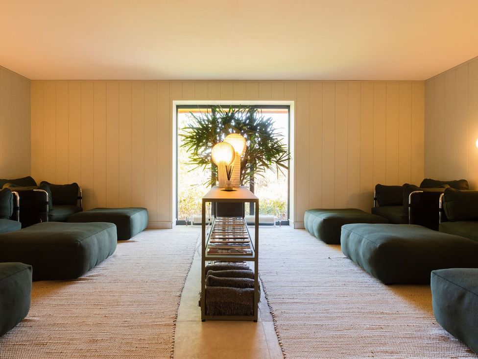 A living room with seating and a table at Dovecote in Waltham