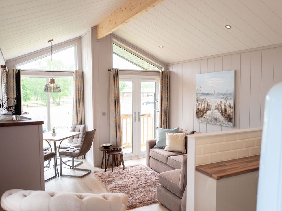 A living room with a sofa and dining table at The Henley in Waltham