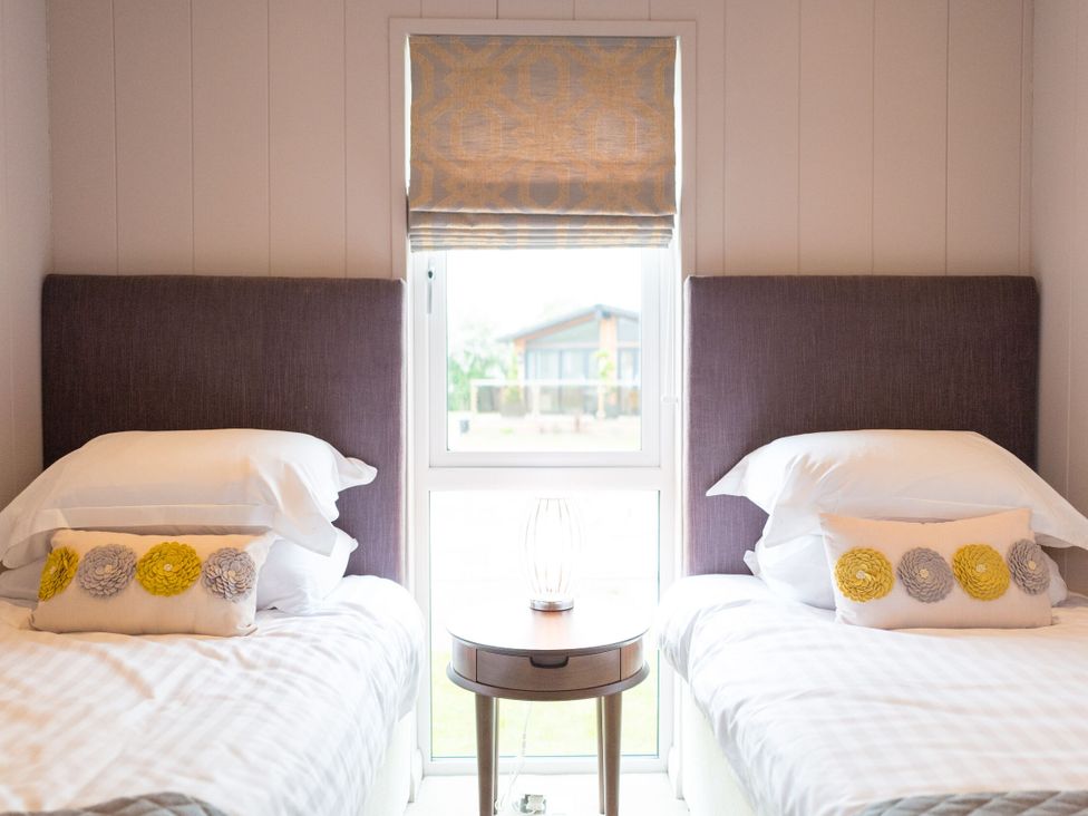 A bedroom with two beds and a window at The Henley in Waltham