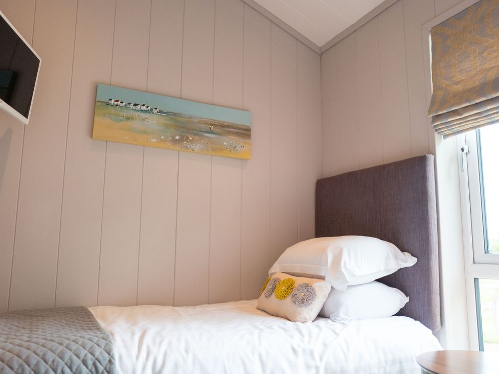 A bedroom with a bed, pillow, and painting at The Henley in Waltham