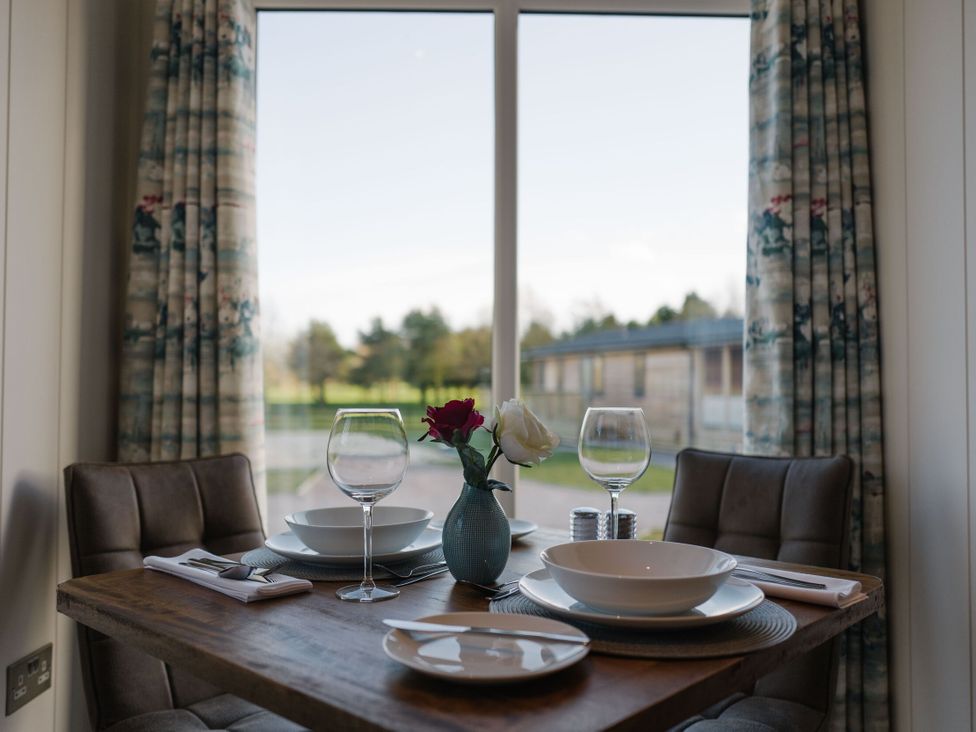A dining room setup with table and chairs at The Henley in Waltham