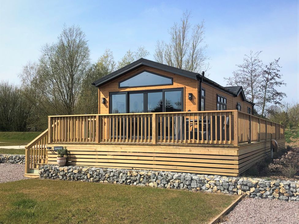 A house with a deck and large windows at Shangri-La in Waltham