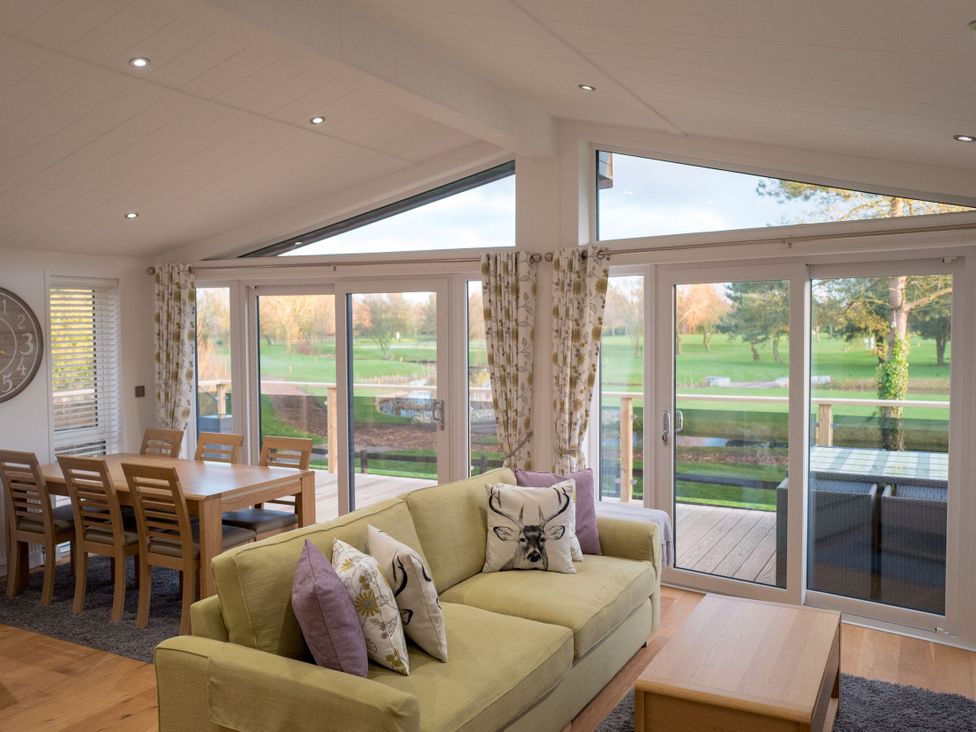 A living room with a sofa and dining area at The Royal in Waltham
