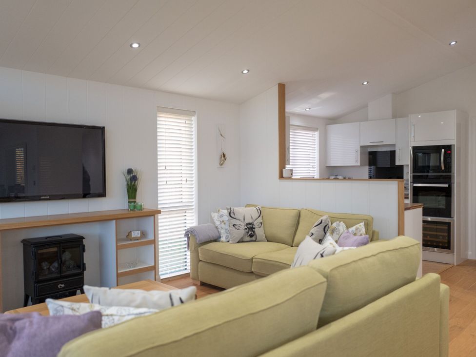 A living room with a sofa and television at The Royal in Waltham