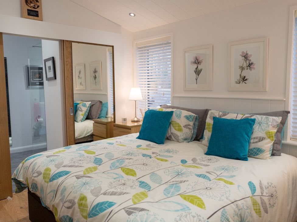 A bedroom with a bed and bedside table at The Royal in Waltham