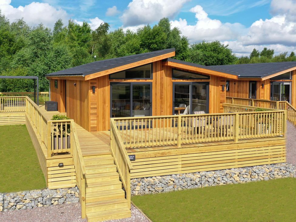 A wooden cabin with decking and steps at The Luxury Retreat in Waltham