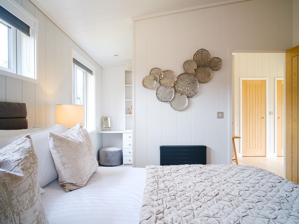 A bedroom with a bed, lamp, and desk at The Luxury Retreat in Waltham