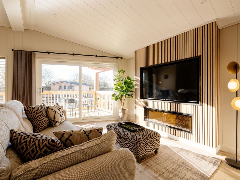 A living room with a sofa and television at Luxury Boutique Retreat Spa in Waltham