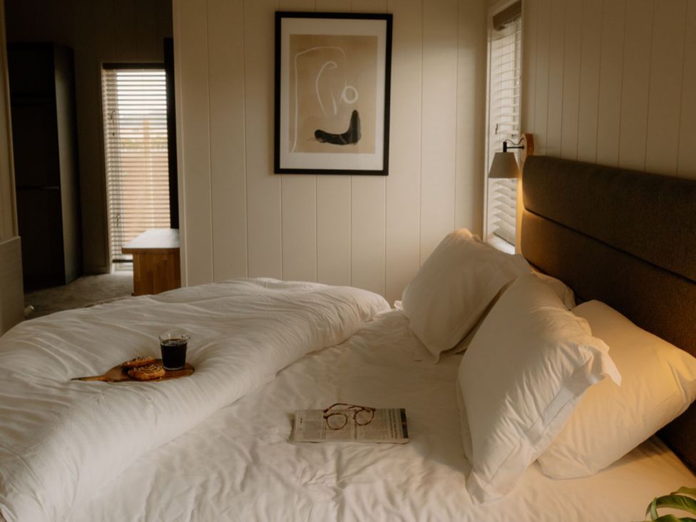 A bedroom with a bed, coffee, and glasses at Luxury Boutique Retreat Spa in Waltham
