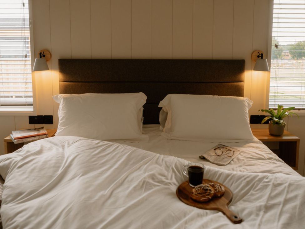 A bedroom with a bed and nightstands at Luxury Boutique Retreat Spa in Waltham
