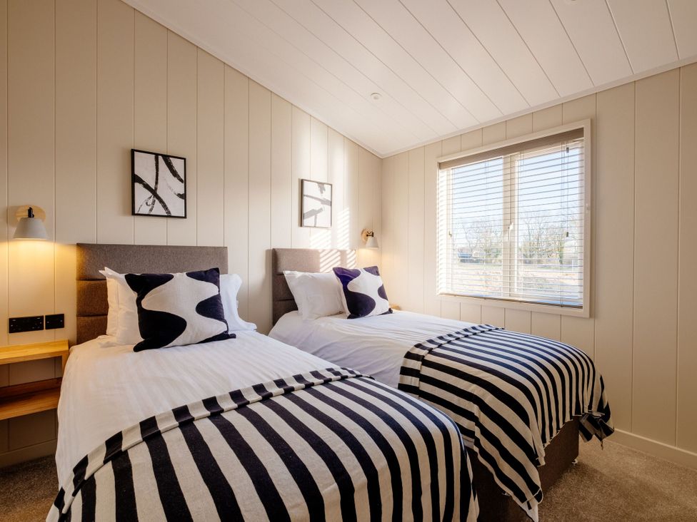 A bedroom with two beds and a window at Luxury Boutique Retreat in Waltham