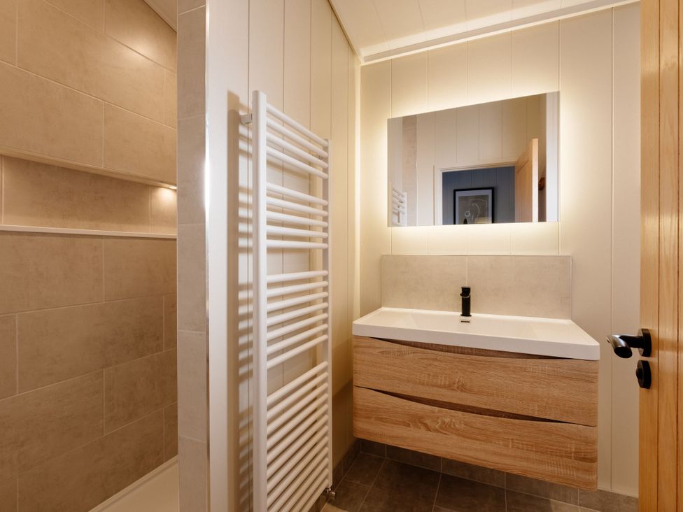 A bathroom with a sink and mirror at Luxury Boutique Retreat in Waltham