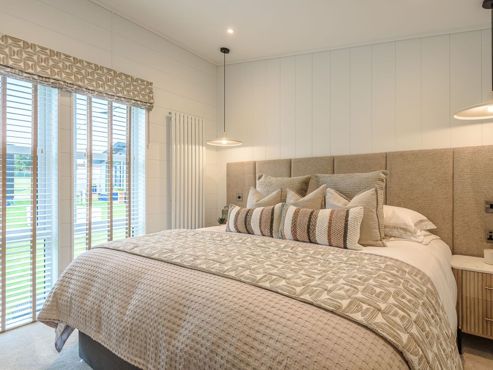 A bedroom with a bed and window at Exclusive Aura Spa in Waltham