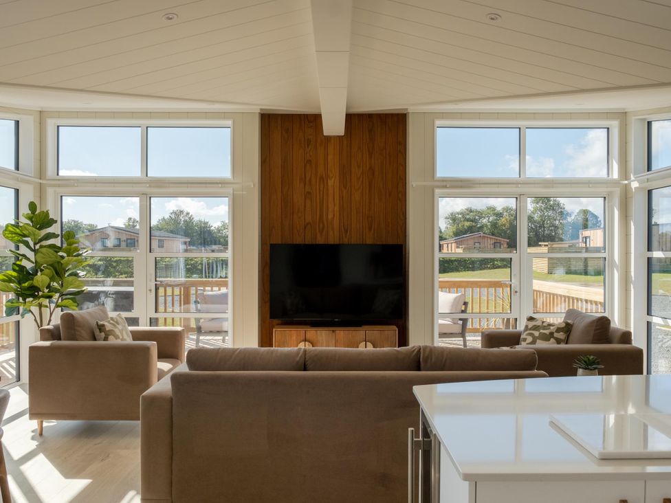 A living room with a television and sofas at Exclusive Aura Spa in Waltham