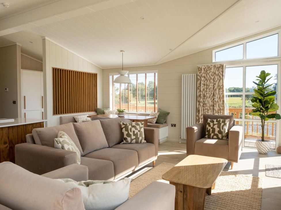 A living room with two sofas and a dining table at Exclusive Aura Spa Waltham