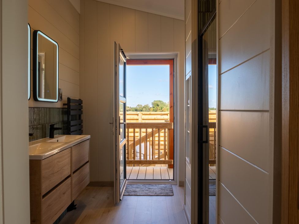A bathroom with a sink and towel radiator at Exclusive Aura Spa Waltham