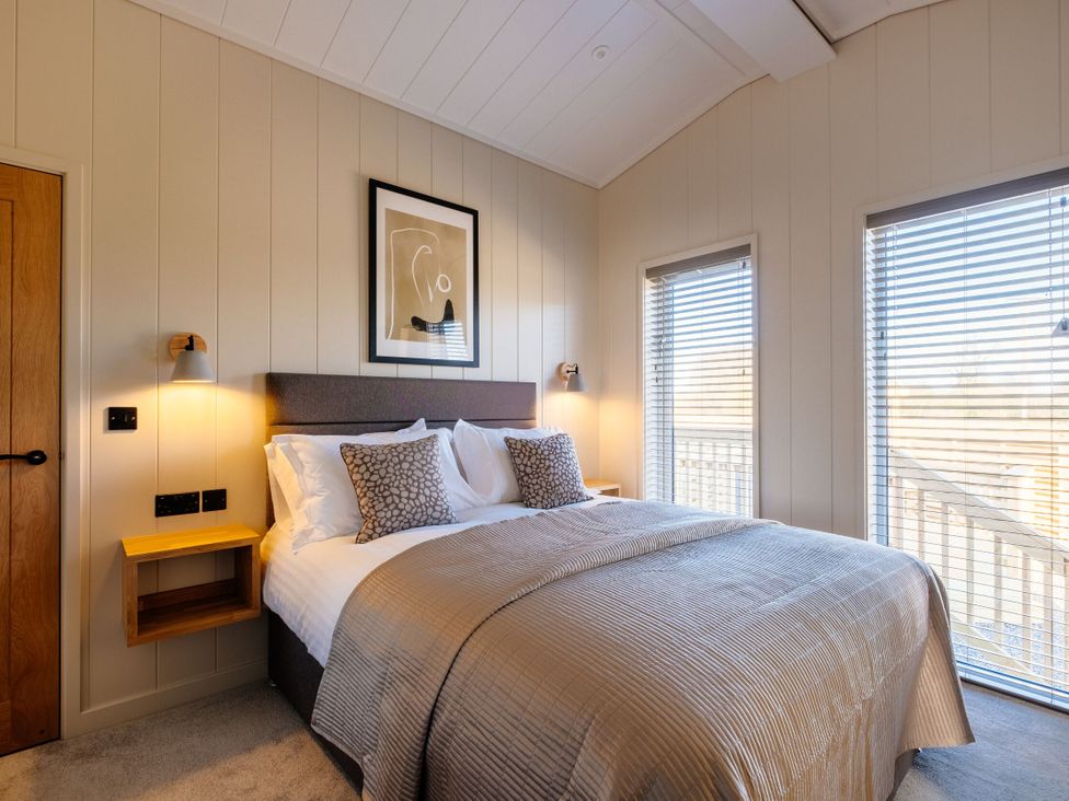 A bedroom with a bed and windows at Luxury Boutique Retreat Pet in Waltham