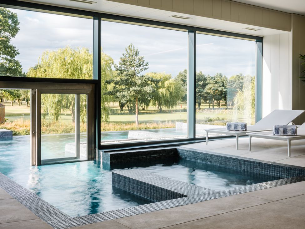 An indoor pool area with a hot tub and lounge chairs at Luxury Boutique Retreat Pet, Waltham