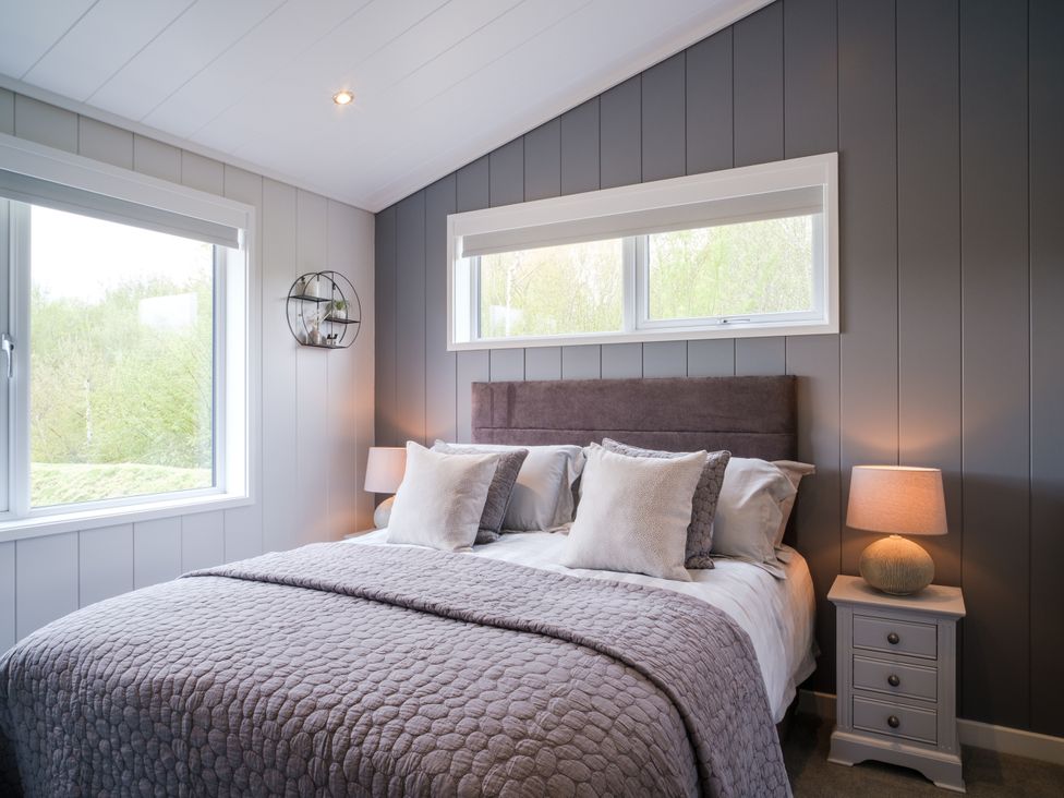 A bedroom with a bed and windows at Hamilton in Waltham