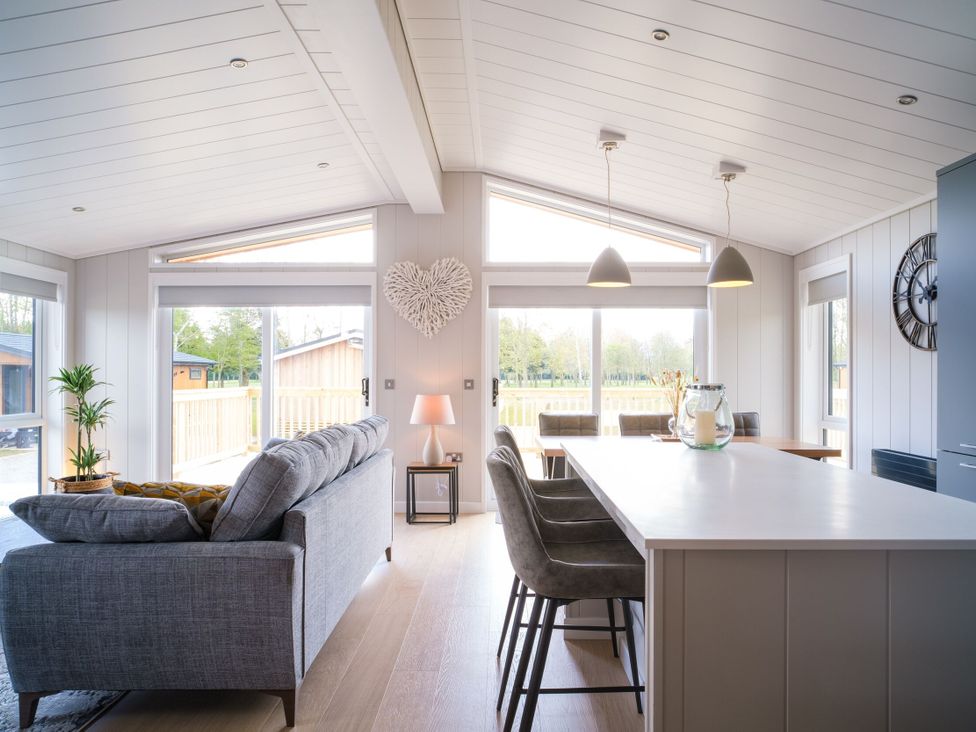 A living room with a sofa and kitchen island at Marrakech in Waltham