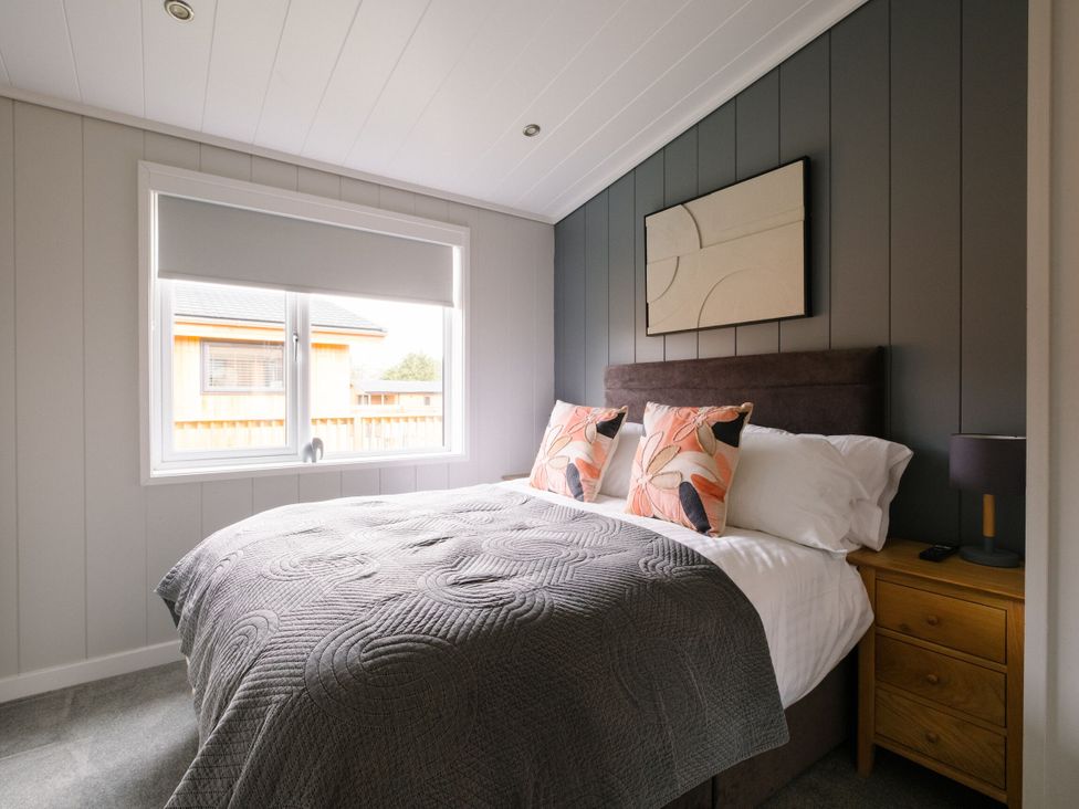 A bedroom with a bed, pillows, and a lamp at Marrakech in Waltham