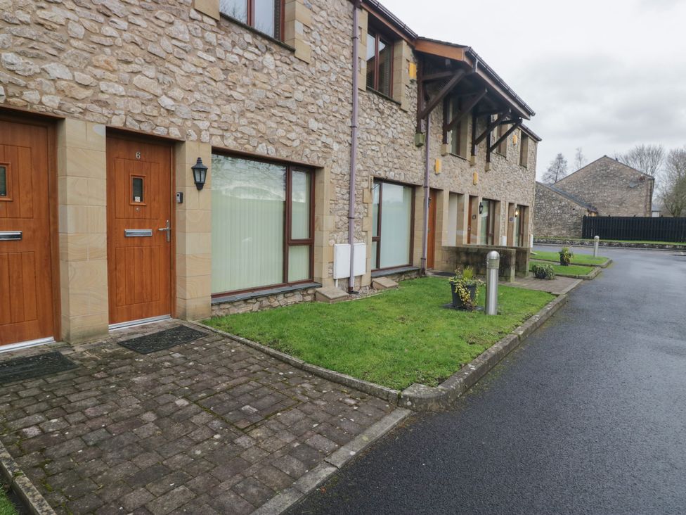 An outdoor view of two wooden doors at 6 Swan House in Tewitfield