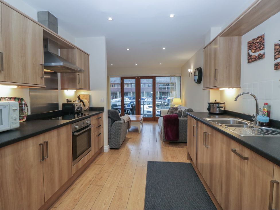 A kitchen with appliances and a seating area at 6 Swan House Tewitfield