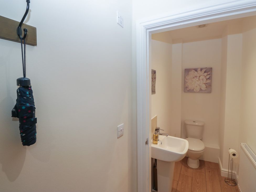 A bathroom with a toilet and sink at 6 Swan House in Tewitfield
