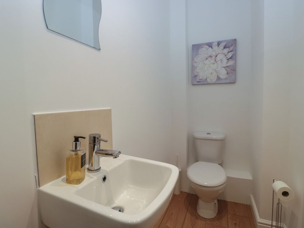 A bathroom with a sink and toilet at 6 Swan House in Tewitfield