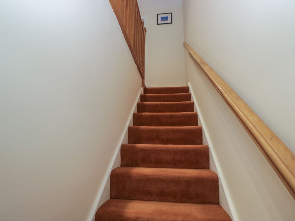A staircase with carpet and a handrail at 6 Swan House Tewitfield