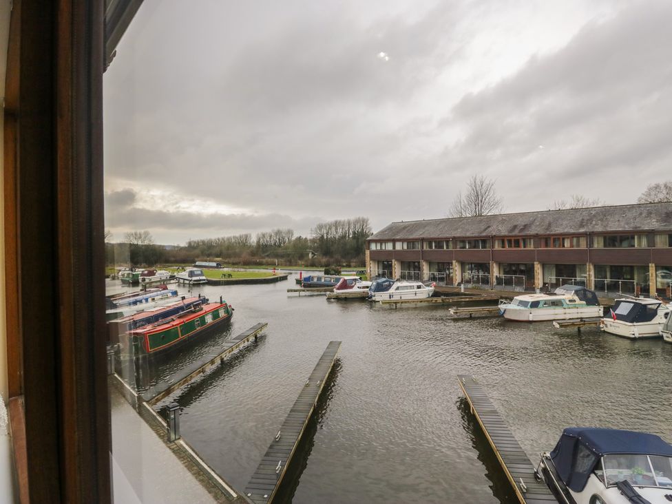 A marina with boats and a building at 6 Swan House in Tewitfield
