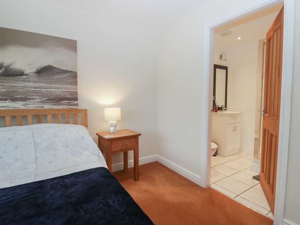 A bedroom with a bed and an adjoining bathroom at 6 Swan House Tewitfield