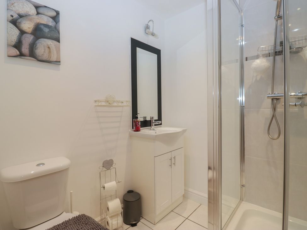 A bathroom with a sink, toilet, and shower at 6 Swan House Tewitfield
