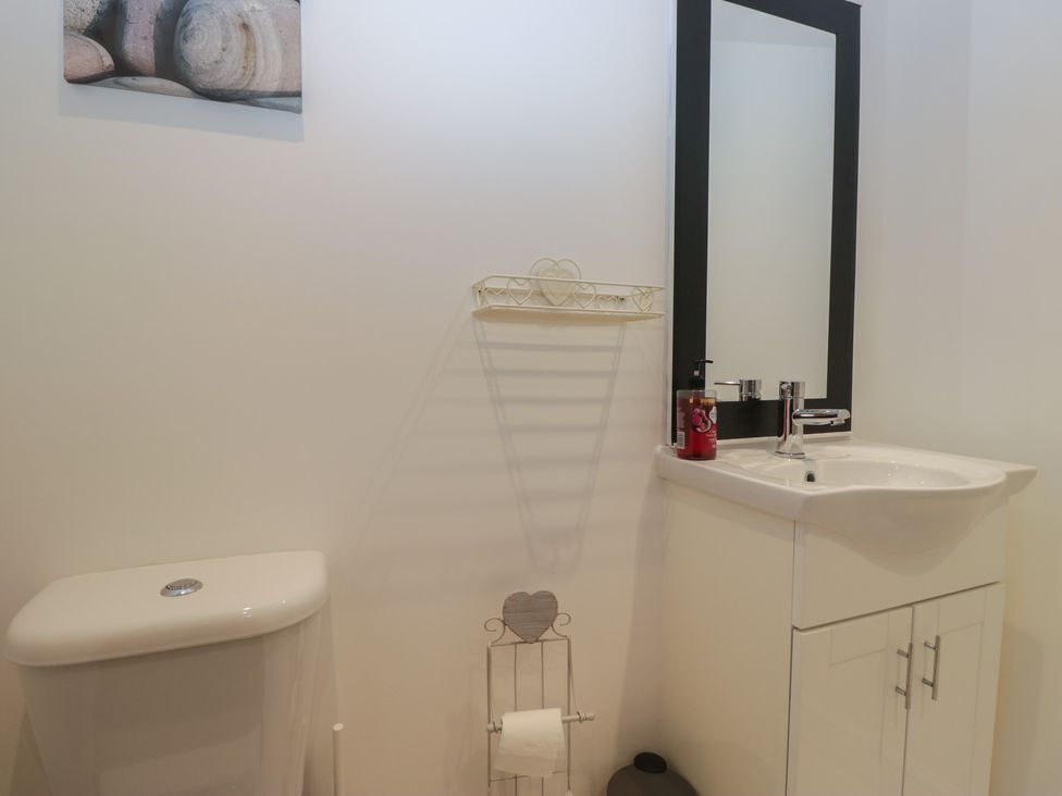 A bathroom featuring a toilet and sink at 6 Swan House Tewitfield