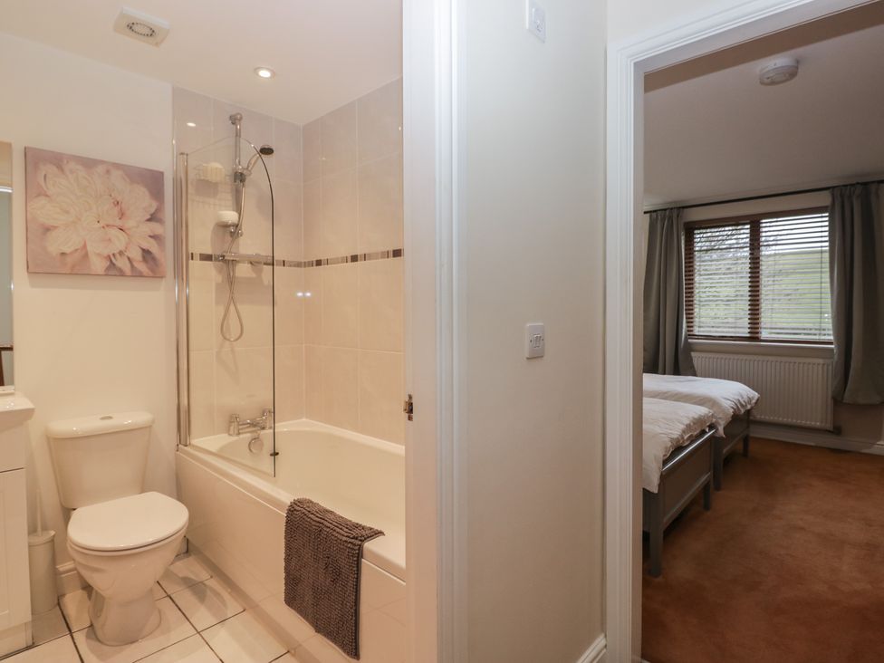 A bathroom with a bathtub and a toilet at 6 Swan House in Tewitfield