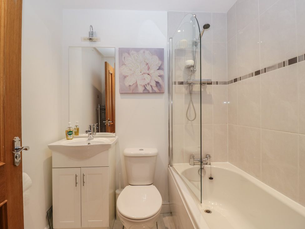 A bathroom with a shower and bathtub at 6 Swan House in Tewitfield