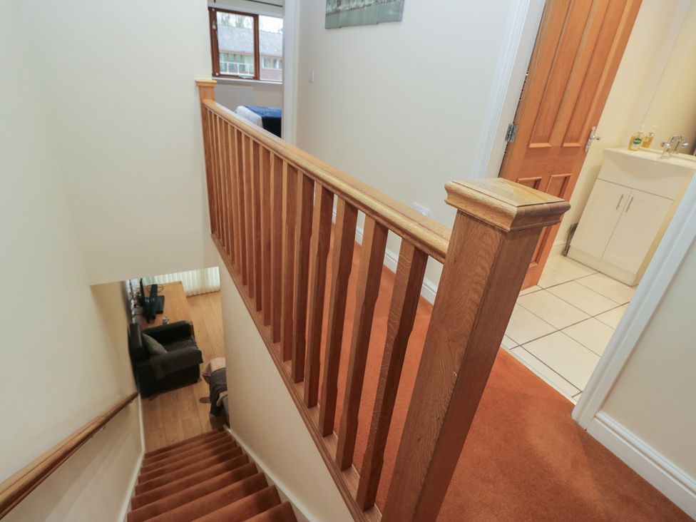 A staircase leading to a hallway with a bathroom at 6 Swan House in Tewitfield