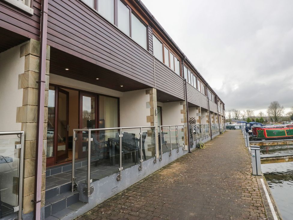 A building with balconies near the water at 6 Swan House in Tewitfield