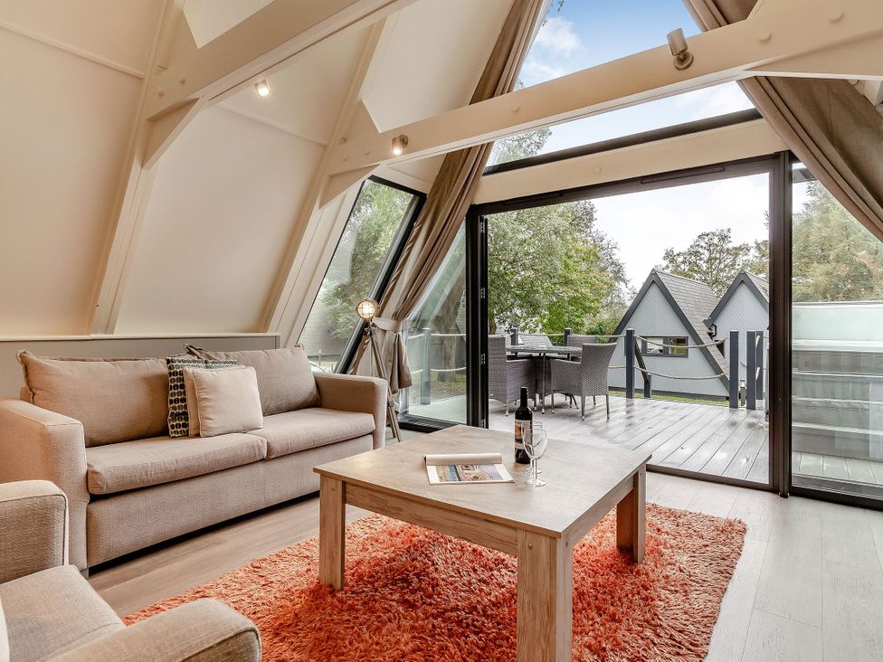 A living room with a couch and coffee table at St Ives Studio Spa in Praze-An-Beeble