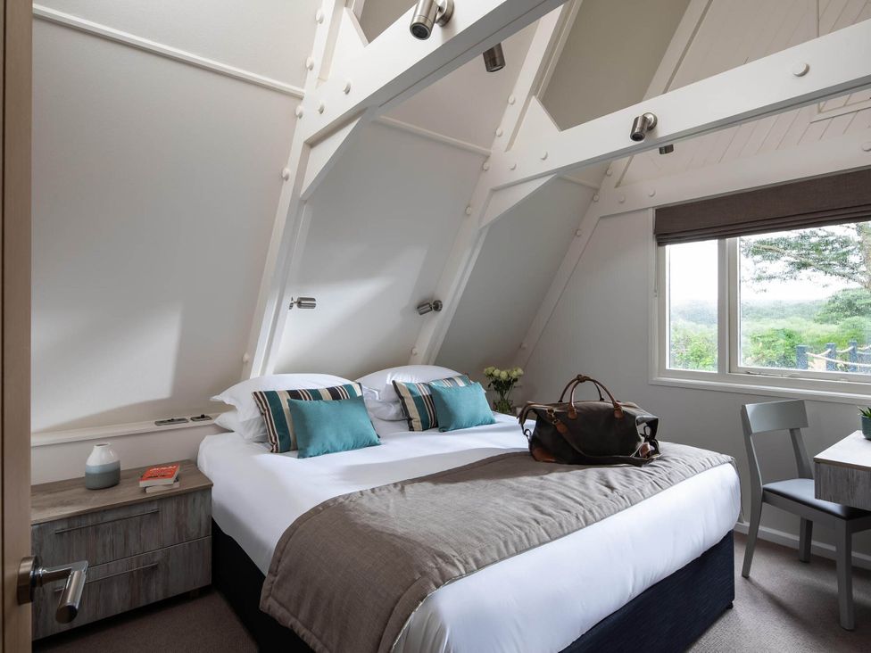 A bedroom with a bed and nightstand at St Ives Lodge 2 Spa Praze-An-Beeble