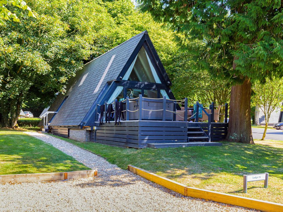 A house with a deck and trees at St Ives Lodge 2 Spa Praze-An-Beeble