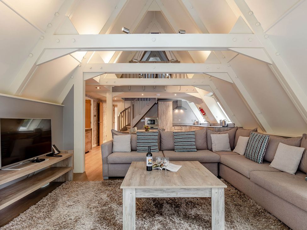 A living room with a sofa and TV at St Ives Lodge 3 Spa in Praze-An-Beeble