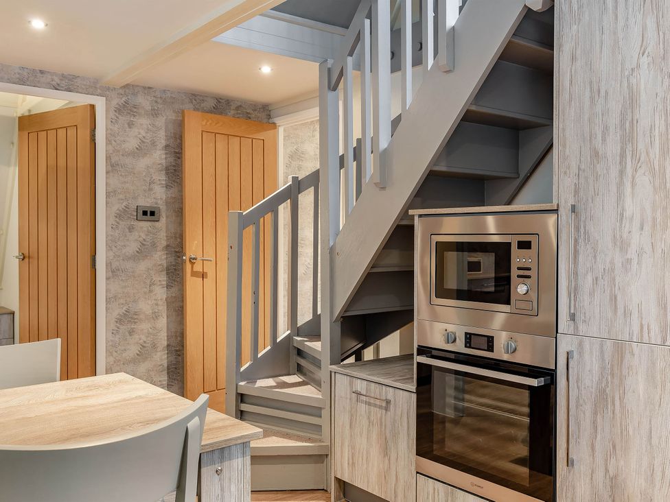 A kitchen with an oven and microwave at St Ives Lodge 3 Spa in Praze-An-Beeble