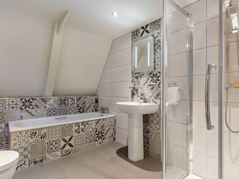 A bathroom with a bathtub, shower, sink, and toilet at St Ives Lodge 3 Spa Praze-An-Beeble