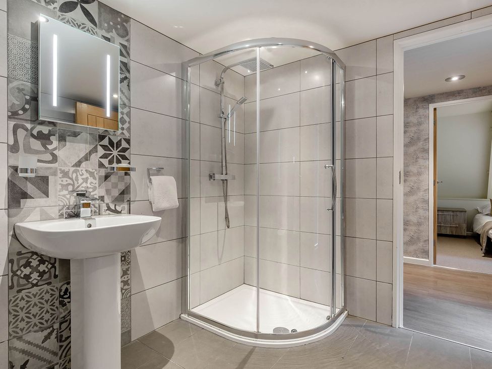 A bathroom with a shower and wash basin at St Ives Lodge 3 Spa in Praze-An-Beeble
